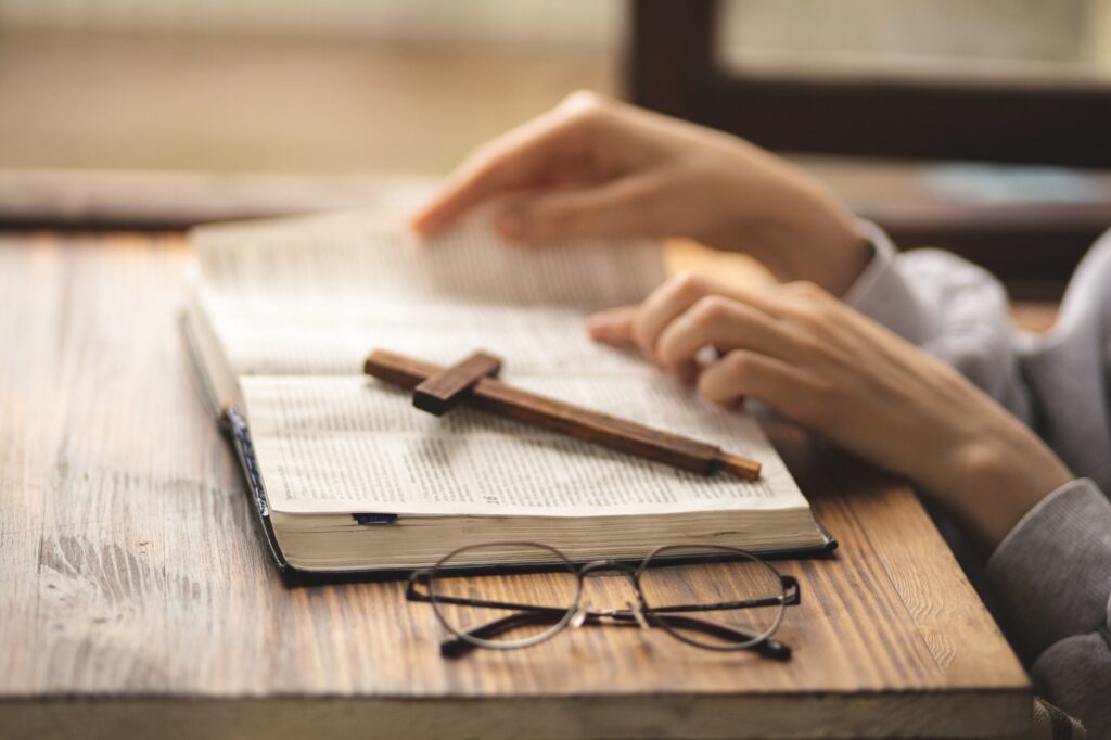 close up of hands on the bible bible study prayer faith and religion believer praying .jpg